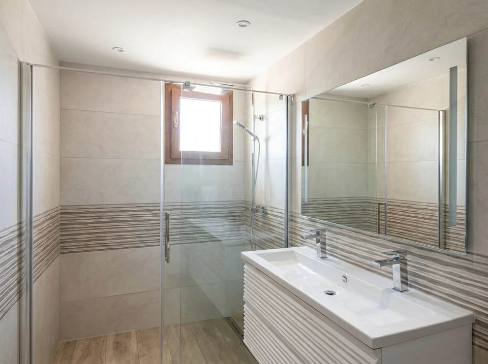Salle de bain moderne avec double vasque à poser sur meuble laqué blanc et plan en bois massif