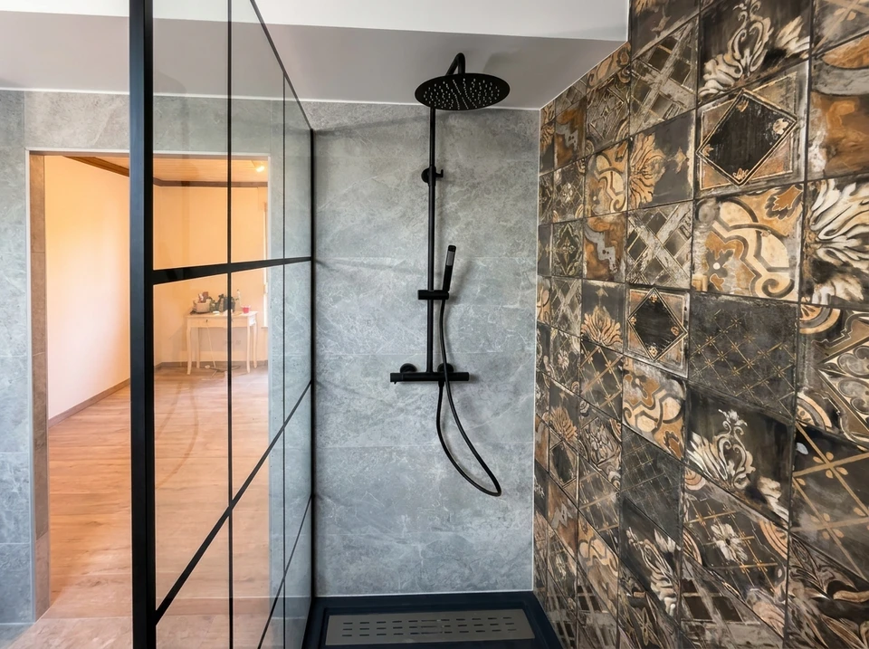Salle de bain moderne r&eacute;nov&eacute;e avec baignoire-douche blanche, robinetterie chrom&eacute;e et carrelage m&eacute;tro blanc